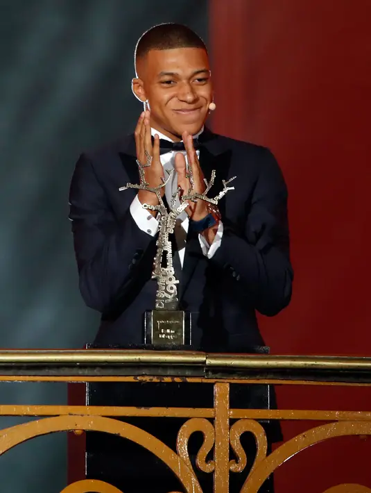 Striker Paris Saint-Germain, Kylian Mbappe menerima penghargaan Trophee Kopa pada seremoni Ballon d'Or 2018 di Grand Palais, Senin (3/12). Mbappe menjadi pemain pertama dalam sejarah yang memenangi penghargaan Trophee Kopa. (AP/Christophe Ena)