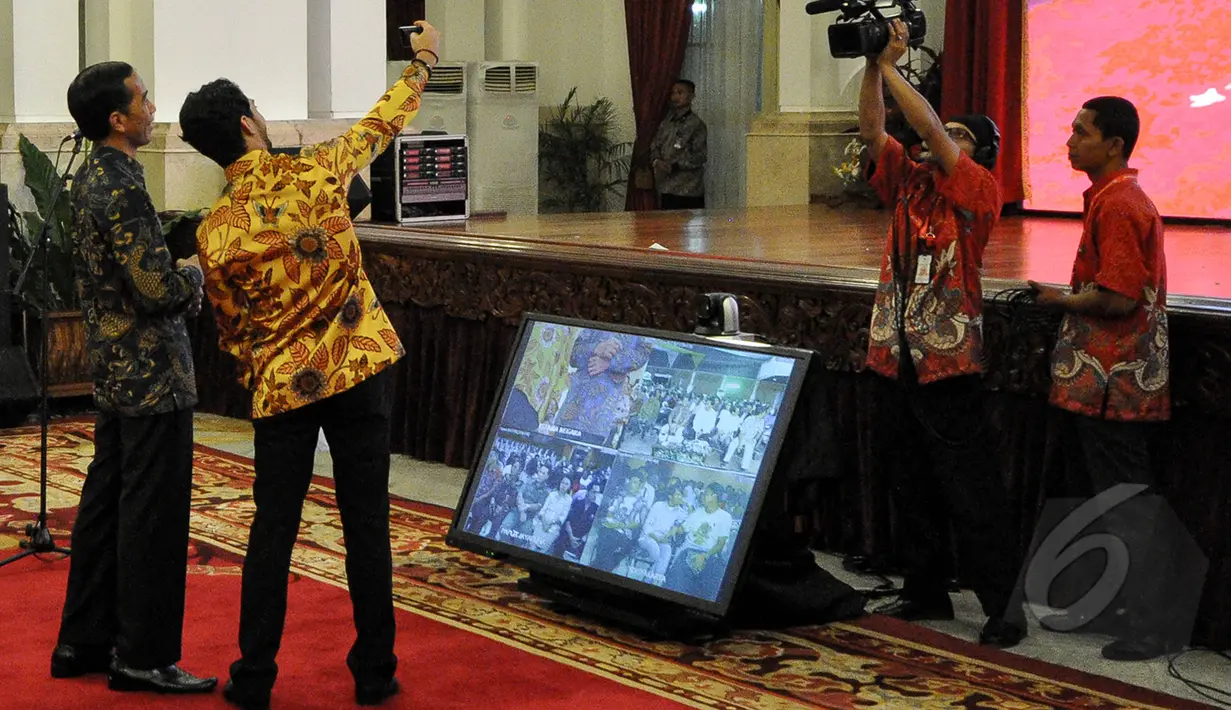 Artis Reza Rahardian berfoto selfie dengan Presiden Joko Widodo di peringatan Hari Film Nasional ke-65 di Istana Negara, Jakarta, Senin (30/3/2015). (Liputan6.com/Faizal Fanani)