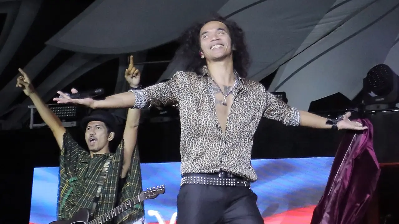 Vokalis Slank, Kaka, bersama Ridho (kiri) dalam konser HUT ke-35 Slank Indonesia Now di GBK, Minggu (23/12). (Bambang Eros/Fimela)