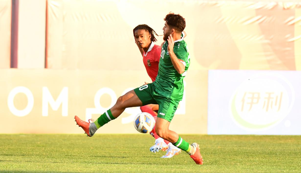 <p>Pemain Timnas Indonesia U-20, Ronaldo Kwateh melepaskan umpan yang berusaha dihalangi pemain Irak U-20, Charbel Awni Shamoon pada laga matchday pertama Grup A Piala Asia U-20 2023 di Lokomotiv Stadium, Tashkent, Uzbekistan, Rabu (1/3/2023). (the-afc.com)</p>