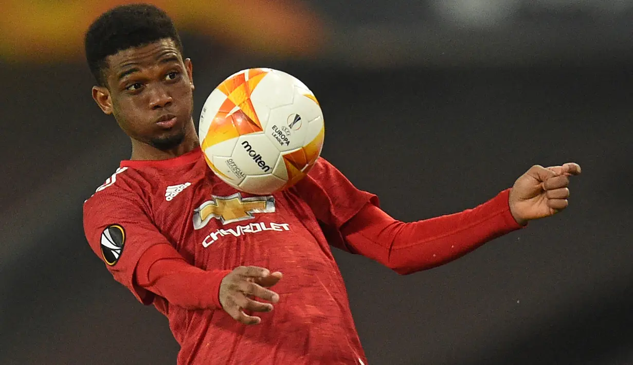 Gelandang Manchester United, Amad Diallo mengontrol bola saat menghadapi Granada pada laga leg kedua Liga Europa 2020/2021 di Old Trafford Stadium, Manchester (15/4/2021). Amad Diallo asal Pantai Gading yang baru saja kembali dari semusim masa peminjaman bersama Sunderland, didatangkan Manchester United dari Atalanta pada tengah musim 2020/2021. Masih belum mampu menembus tim utama, hingga kini ia baru bermain dalam 9 laga dengan torehan 1 gol dan 1 assist. (AFP/Oli Scarff)