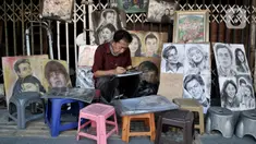 Seniman lukis menyelesaikan karyanya di pinggir Jalan Pintu Besar Selatan, Pinangsia, Jakarta, Selasa (2/6/2020). Sejumlah seniman memilih tutup sementara di tengah pandemi virus corona COVID-19, sedangkan beberapa lainnya tetap bertahan demi mendapatkan penghasilan. (merdeka.com/Iqbal S. Nugroho)