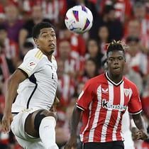 Pemain Real Madrid, Jude Bellingham, berebut bola dengan pemain Athletic Bilbao, Nico Williams, pada laga pekan ke-1 La Liga 2023/2024 di Stadion San Mames, Minggu (13/8/2023). Los Blancos menang dengan skor 2-0. (AP Photo/Alvaro Barrientos)