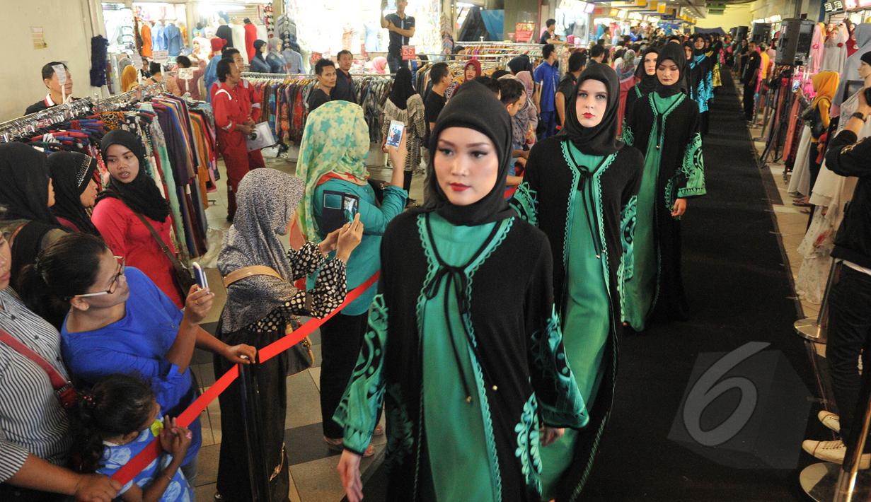 Sejumlah model berjalan di atas catwalk memperagakan busana muslim rancangan Itang Yunasz bertajuk Puspa Ragam Andalas di Pusat Grosir Blok B Tanah Abang, Jakarta, Kamis (30/4/2015). (Liputan6.com/Herman Zakharia)