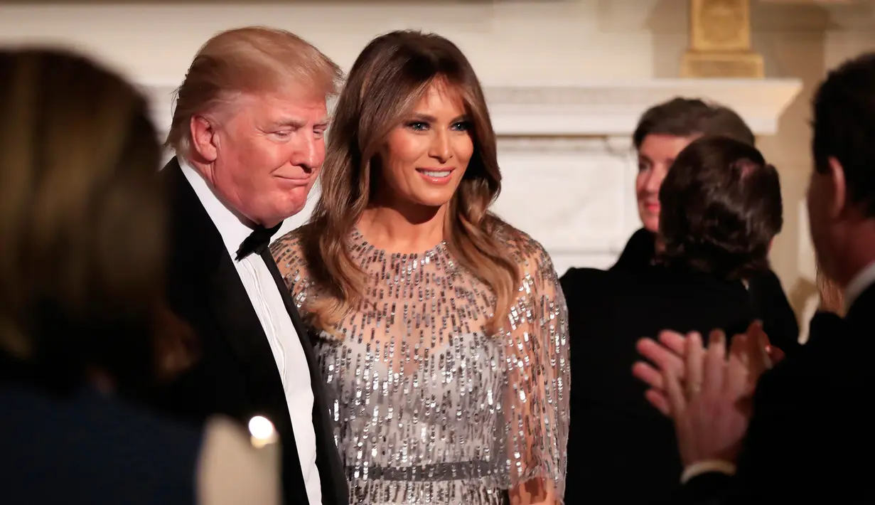 Presiden AS, Donald Trump dan Melania Trump berbincang pada acara jamuan makan malam White House Historical Association, Jumat (15/9). Melania berbalut gaun dengan manik-manik silver yang harganya mencapai Rp106 juta. (AP Photo/Manuel Balce Ceneta)