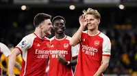 Wajah gembira para pemain Arsenal merayakan gol yang dicetak Martin Odegaard ke gawang Wolverhampton dalam lanjutan Liga Inggris 2023/2024, Minggu (21/4/2024) dini hari WIB. ((Nick Potts/PA via AP)