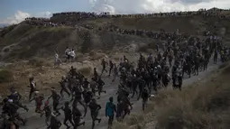 Para peserta dengan tubuh dilumuri minyak hitam mengikuti Festival Tradisionlal Cascamorras di Baza, Granada, Spanyol (6/9/2019). Festival Cascamorras merupakan tradisi warga Spanyol yang sudah dirayakan sejak 500 tahun lalu. (AFP Photo/Jorge Guerrero)