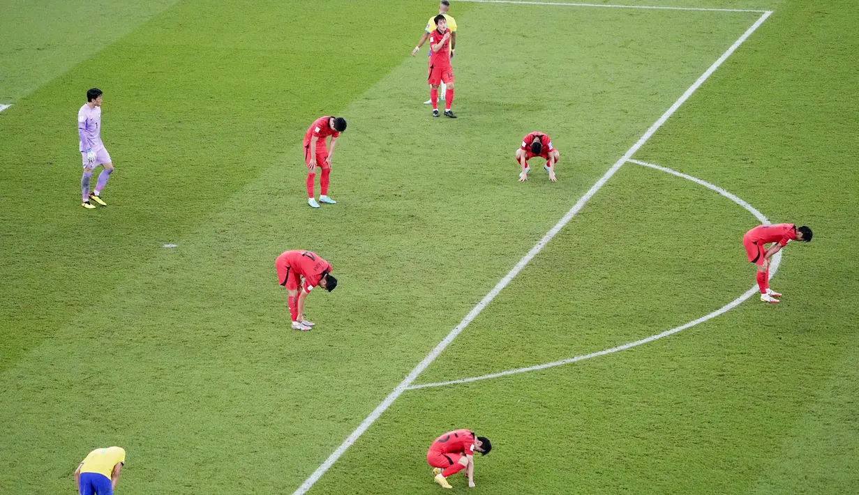 Pemain Korea Selatan tertunduk lesu usai ditaklukkan Brasil pada babak 16 besar Piala Dunia 2022. Taeguk Warriors takluk 1-4 dari Brasil. (AP/Ariel Schalit)