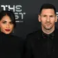 Pemain Paris Saint-Germain asal Argentina, Lionel Messi (kanan) dan istrinya Antonela Roccuzzo berpose setibanya pada acara The Best FIFA Football Awards 2022 di Paris, Prancis, 27 Februari 2023. Messi dan Antonella mencuri perhatian saat menghadiri The Best FIFA Football Awards 2022. (FRANCK FIFE/AFP)