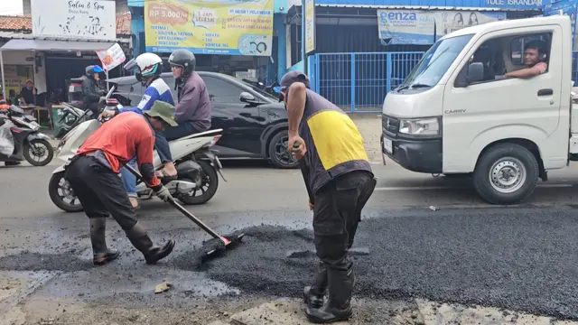 DPUPR Kota Depok melakukan perbaikan jalan berlubang di Jalan Raya Tole Iskandar, Depok.