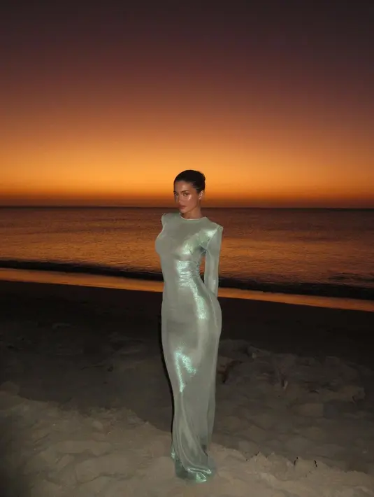 Kylie Jenner tampil stunning saat mengenakan long sleeve shimmer dress. Dress model bodycon tersebut mengikuti bentuk tubuh Kylie dengan sempurna. [@kyliejenner]