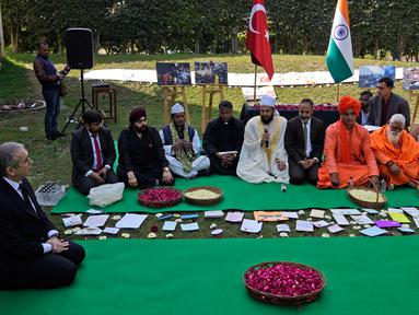 Duta Besar Turki untuk India Fırat Sunel (kiri) memimpin pertemuan doa antaragama untuk memberi penghormatan kepada para korban gempa Turki dan Suriah di Kedutaan Besar Turki, New Delhi, India, Selasa (21/2/2023). (AP Photo/Manish Swarup)