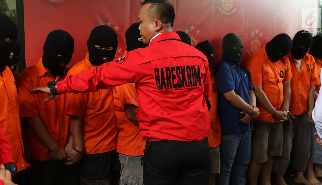 Sejumlah tersangka dihadirkan dalam rilis kasus pemalsuan dokumen dan uang palsu di Jakarta, Rabu (20/12). Bareskrim Polri mengamankan barang bukti berupa 22 unit kendaraan serta beberapa ikat uang palsu yang belum dipotong. (Liputan6.com/Angga Yuniar)