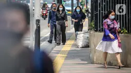 Sejumlah pegawai perkantoran di Jalan Sudirman, Jakarta, Rabu (29/7/2020). Perkantoran, khususnya kantor pemerintahan, menjadi sumber kluster baru terbesar selain permukiman dan pasar. (Liputan6.com/Faizal Fanani)