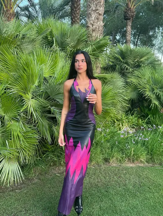 Di acara makan malam ulang tahunnya, Dua Lipa tampil sempurna dengan skintight black leather halter top gown dari Mugler. Perpaduan warna pink dan violet membuat penampilan Dua Lipa terlihat gahar. (instagram/dualipa)