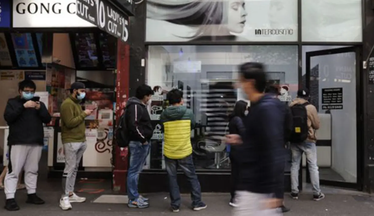 Warga yang mengenakan masker mengantre untuk memangkas rambut mereka di Central Business District (CBD) Melbourne, Negara Bagian Victoria, Australia, 19 Oktober 2020. PM Australia Scott Morrison merilis pernyataan guna menyambut pelonggaran lockdown secara parsial di Victoria. (Xinhua/Bai Xue)