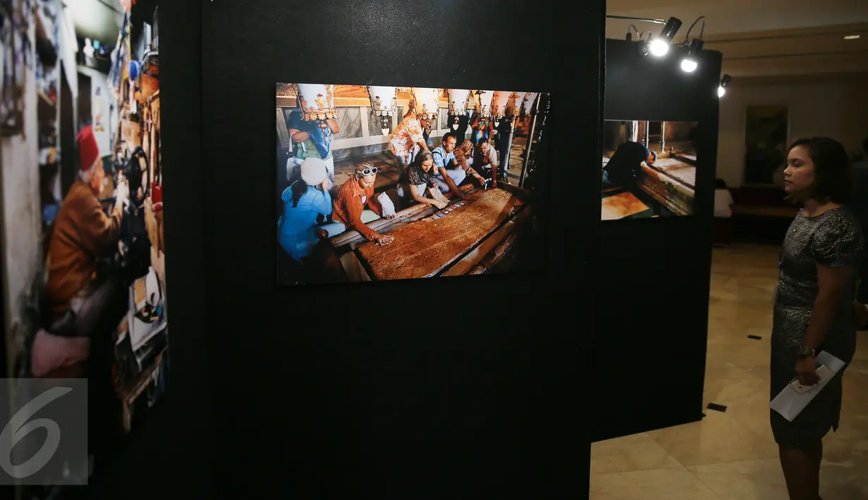 Seorang pengunjung menikmati karya-karya dalam pameran foto Yerussalem di Hotel Borobudur, Jakarta, Senin (14/12/2015). Pameran tersebut menceritakan kehidupan sehari-hari di kota suci tersebut antara umat Muslim dan Nasrani. (Liputan6.com/Faizal Fanani)