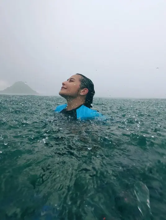 Melalui akun instagramnya, perempuan kelahiran Tangerang 26 tahun silam itu membagikan videonya saat renang di laut dengan cuaca hujan.[Instagram/prillylatuconsina96]
