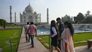 Turis mengunjungi Taj Mahal setelah dibuka kembali untuk pengunjung menyusul pelonggaran pembatasan virus corona Covid-19 di Agra, Inida, Rabu (16/6/2021). Taj Mahal ditutup untuk umum pada awal April 2021 ketika India memberlakukan tindakan penguncian ketat. (Money SHARMA/AFP)