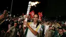 Supermodel Adriana Lima membawa obor pada malam penyambutan Olimpiade Rio 2016 di Maua Square Rio de Janeiro, Brasil, Kamis (4/8). (REUTERS / Pilar Olivares)