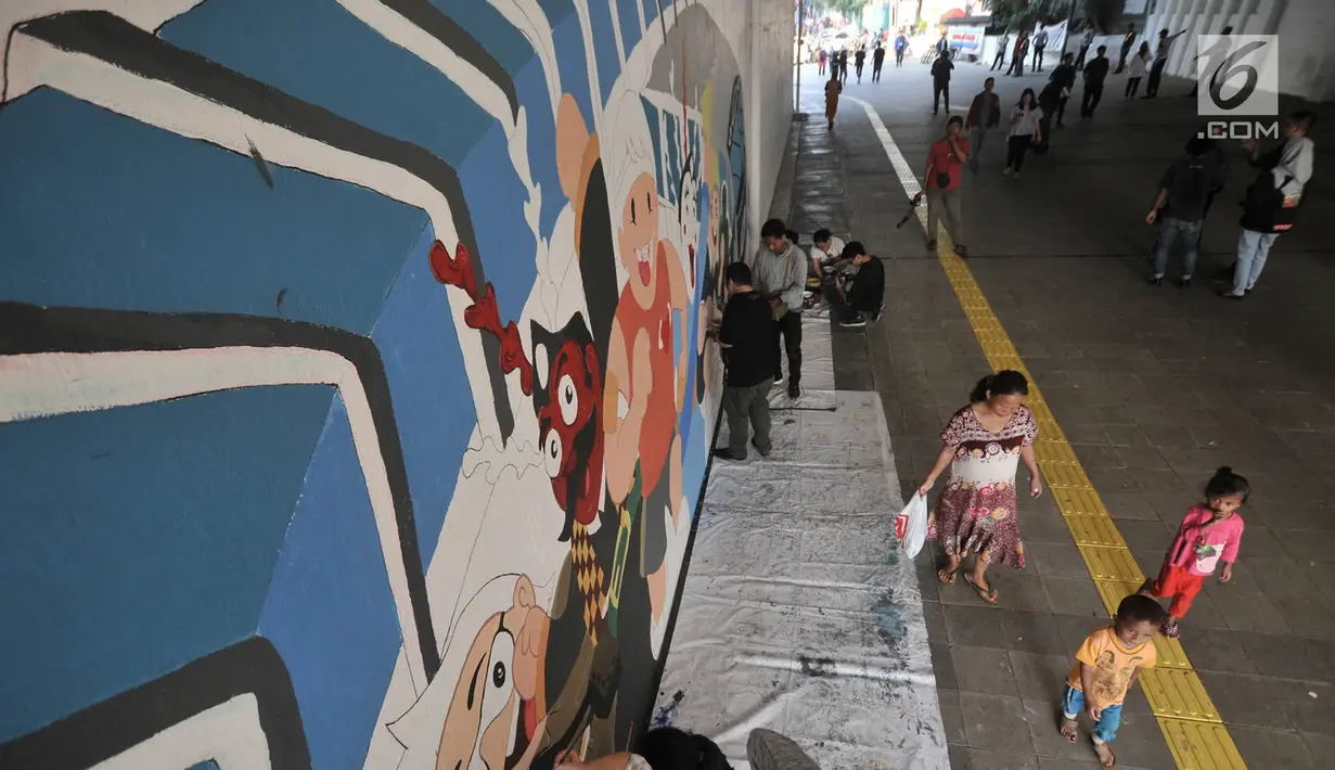 Pejalan kaki saat melintasi mural Wajah Baru Jakarta di terowongan Jalan Kendal, Jakarta, Kamis (20/6/2019). Mural tersebut dibuat dalam rangka menyambut HUT ke-492 DKI Jakarta sekaligus mempercantik lingkungan. (merdeka.com/Iqbal S. Nugroho)