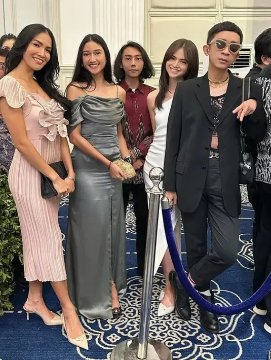 Aming tampak dengan setelan jas hitam, lalu Aulia cantik dengan gaun putih [Inistagram/adindathomas]