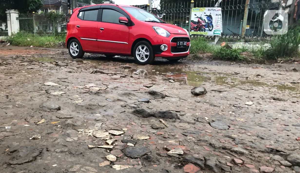 Kendaraan menghindari jalan yang rusak di Jalan Pertamina, Depok, Jawa Barat, Rabu (4/3/2020). Jalan yang telah rusak selama bertahun-tahun tersebut tidak juga diperbaiki sehingga mengganggu kenyamanan para pengguna jalan. (Liputan6.com/Immanuel Antonius)