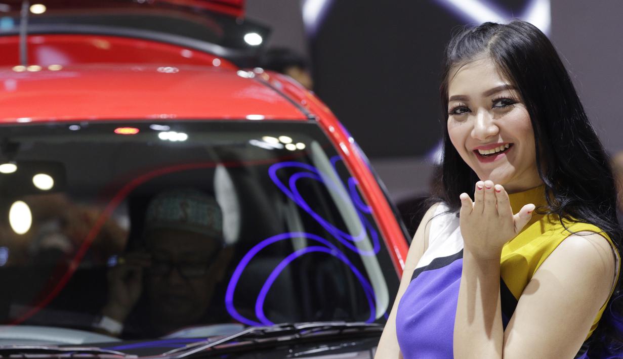 Sales Promotion Girl (SPG) berpose di depan kendaraan yang dipamerkan di GIIAS 2019, ICE BSD, Kamis (25/7). Kehadiran SPG tersebut selain untuk menarik perhatian pengunjung juga bisa memberikan informasi tentang produk. (Bola.com/M Iqbal Ichsan)