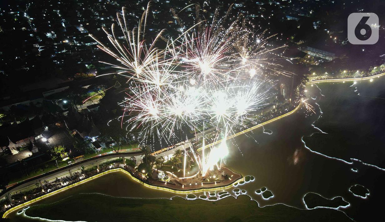 Suasana  pesta kembang api saat perayaan malam puncak Tahun Baru 2023 di Danau Archipelago, Taman Mini Indonesia Indah (TMII), Jakarta, Minggu (1/1/2023). Danau Archipelago TMII menjadi pusat pesta kembang api di malam tahun baru 2023. (Liputan6.com/Herman Zakharia)