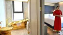 Seorang pegawai berpose di dalam kamar suite eksekutif seharga USD 1.000 per malam di hotel Dolce Hanoi Golden Lake yang baru saja diresmikan di Hanoi, Vietnam pada Kamis (2/7/2020). Hotel tersebut merupakan hotel berlapiskan emas 24 karat pertama di dunia. (Manan VATSYAYANA / AFP)