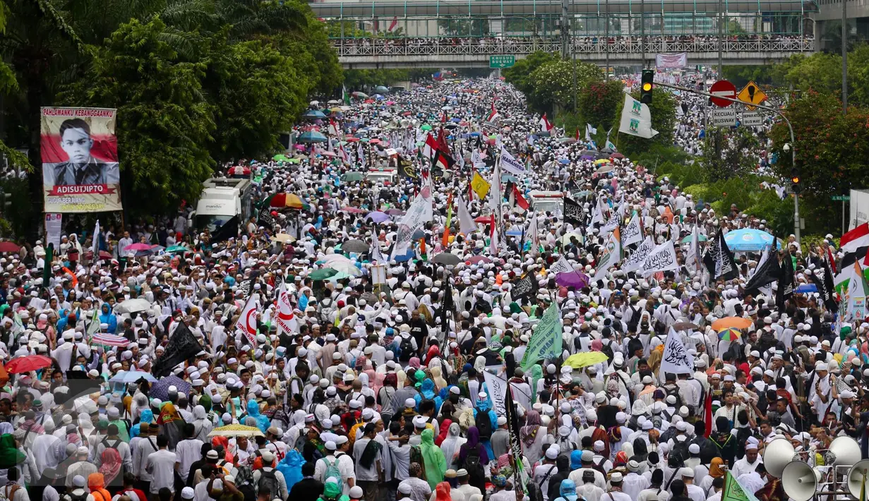 Ribuan peserta aksi damai 2 Desember berjalan kaki sambil berorasi‎ menyusuri Jalan MH Thamrin, Jakarta, Jumat (2/12). Usai melaksanakan salat jumat, massa yang memenuhi dua jalur MH Thamrin itu berjalan kaki menuju Bundaran HI (Liputan6.com/Fery Pradolo)