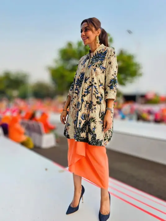 Najwa Shihab memadukan kebaya motif batik dari Oscar Lawalata dan kain lilit berwarna oranye. [Instagram/najwashihab]