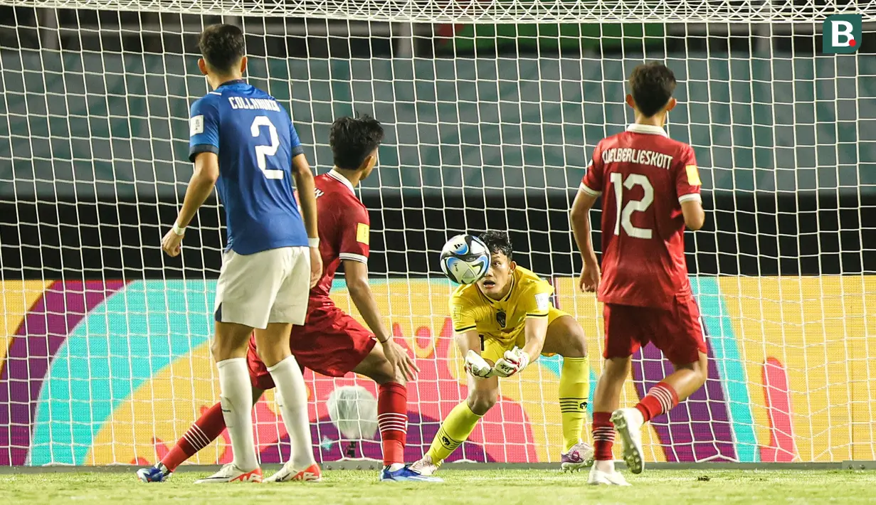 Penjaga gawang Timnas Indonesia U-17, Ikram Al Giffari (tengah) berusaha menangkap bola dalam pertandingan lanjutan Grup A Piala Dunia U-17 2023 melawan Timnas Ekuador U-17 yang berlangsung di Stadion Gelora Bung Tomo, Surabaya, Jumat (10/11/2023). (Bola.com/Bagaskara Lazuardi)