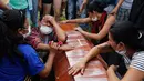 Sejumlah wanita menangis di samping peti mati dalam upacara pemakaman korban banjir dan tanah longsor di Mocoa, Kolombia, (3/4). Musibah ini memakan korban jiwa hingga ratusan orang dan menghancurkan seluruh lingkungan. (AP Photo / Fernando Vergara)