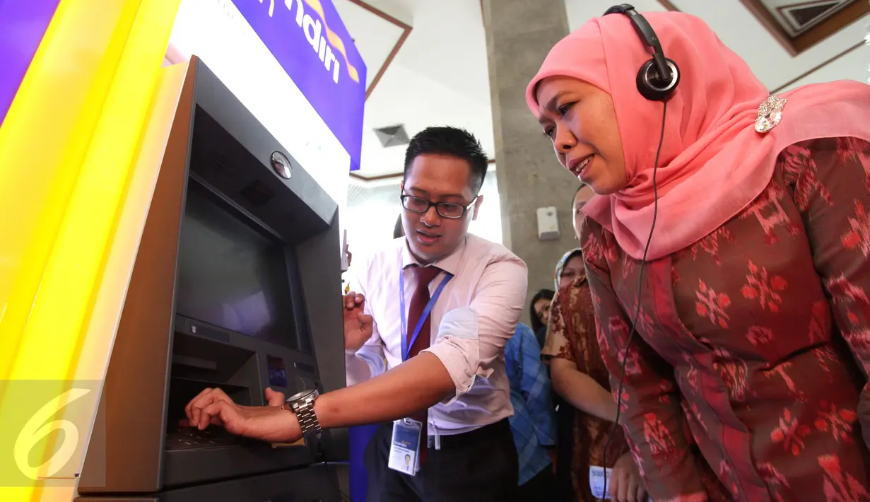 Petugas menunjukkan sistem kerja ATM layanan wicara untuk penyandang disabilitas kepada Mensos Khofifah, Jakarta, (1/12/2015). Uji coba ini untuk memperingati hari disabilitas internasional pada 3 Desember mendatang. (Liputan6.com/Helmi Afandi)