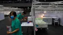 Pekerja medis membuat persiapan di rumah sakit lapangan sementara yang didirikan di Asia World Expo di Hong Kong, Sabtu (1/8/2020). Rumah sakit baru itu akan menerima pasien COVID-19 berusia antara 18 dan 60 tahun dengan sekitar 500 tempat tidur tersedia pada tahap pertama. (AP Photo/Kin Cheung)