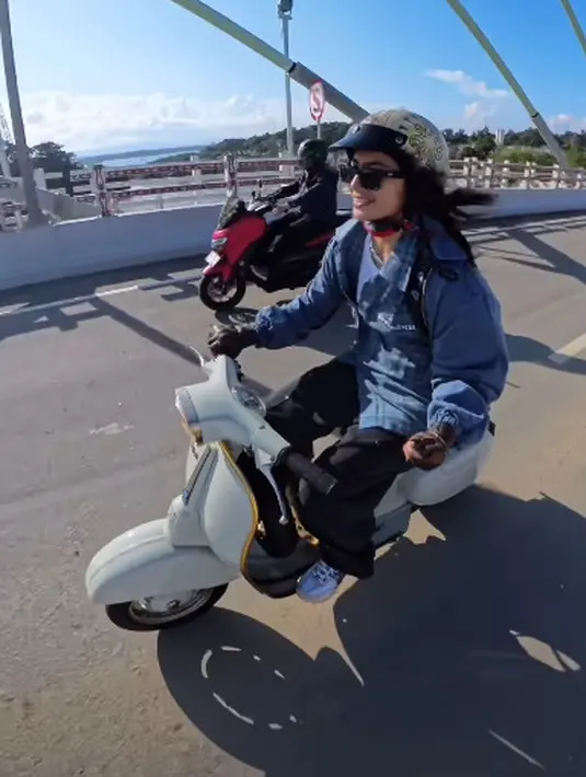 Mengendarai Vespa kesayangan, Sintya Marisca tampil boyish khas anak motor. Ia mengenakan kemeja kotak-kotak dengan oversized denim jacket dan celana cargo berwarna hitam [@sintyamarisca]