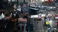 Pandangan dari atas di lokasi dimana truk menabrak kerumunan orang di sebuah pasar Natal di pusat Kota Berlin, Jerman, Senin (19/12). Ambulan dan kendaraan aparat keamanan sesaat kemudian bermunculan di lokasi kejadian. (REUTERS/Pawel Kopczynski)