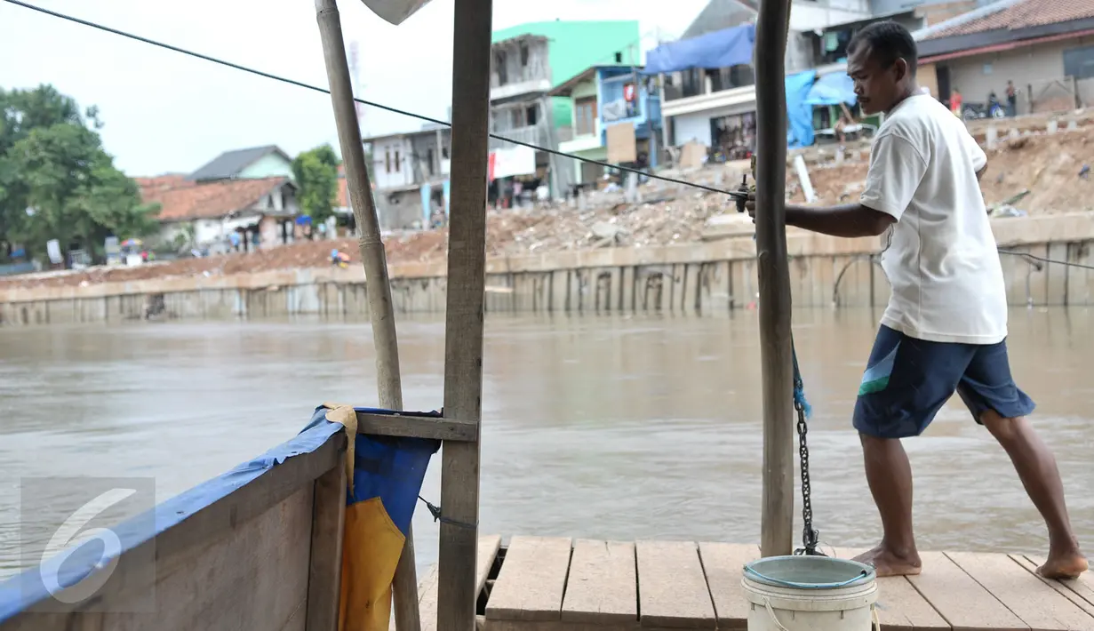 Mami (35) warga asli Kampung Pulo, Jatinegara, Jakarta Timur, merupakan generasi ke-2 penarik perahu eretan di kali Ciliwung yang memisahkan kampungnya dengan Bukit Duri, Jakarta Selatan, Rabu (28/12). (Liputan6.com/Yoppy Renato)