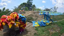 Warga mengangkut kain pantai dengan gerobak usai dijemur di bantaran sungai di Desa Mojolaban , Kabupaten Sukoharjo, Jawa Tengah, Rabu (25/10). (Liputan6.com/Gholib)