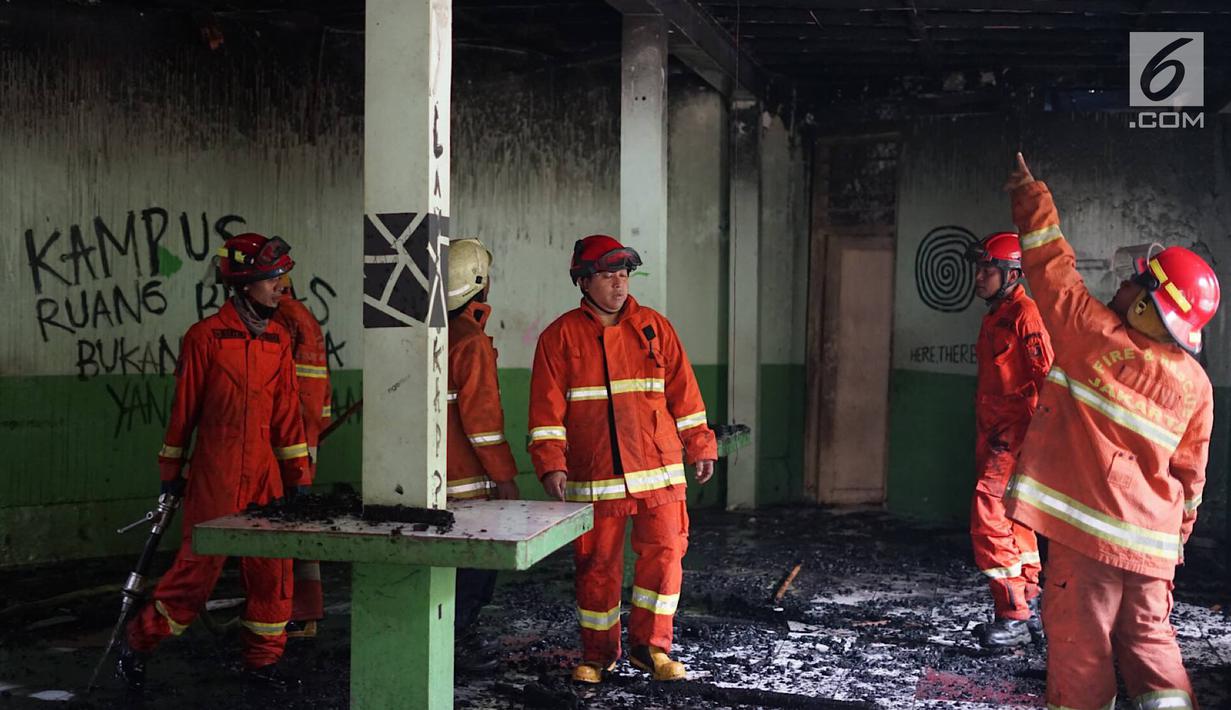 Petugas memeriksa kebakaran yang melanda area kantin kampus Institut Ilmu Sosial dan Ilmu Politik (IISIP), Jakarta, Sabtu (24/8/2019). Enam unit mobil pemadam kebakaran dikerahkan untuk memadamkan api yang melahap bangunan tersebut. (Liputan6.com/Immanuel Antonius)