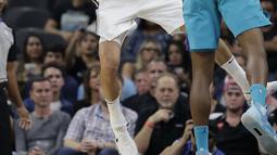 Aksi pemain Spurs, Manu Ginobili (20) melepaskan umpan saat diadang pemain Hornets, Dwight Howard (12) pada laga NBA basketball game di AT&T Center, San Antonio, (3/11/2017) waktu setempat. San Antonio menang 108-101. (AP/Eric Gay)
