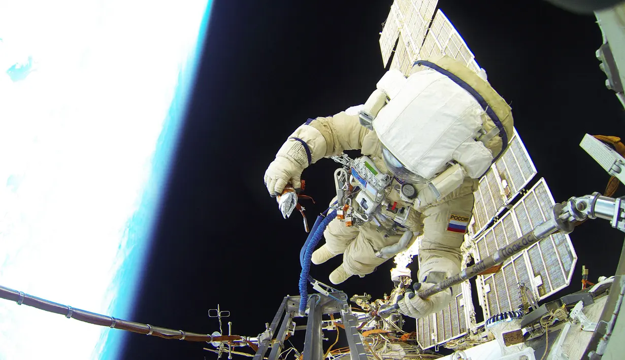 Kosmonot Rusia Sergei Volkov sedang melakukan spacewalk diluar badan Stasiun Luar Angkasa Internasional (ISS), (7/2). Kosmonot Rusia ini hanya berpegang dengan tali untuk melakukan pekerjaannya diluar stasiun ISS. (REUTERS/Roscosmos)