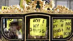 Raja Inggris Charles III dan Ratu Inggris Camilla melakukan perjalanan dengan Diamond Jubilee State Coach melewati para pengunjuk rasa yang memegang plakat "Not My King" dari kelompok anti-monarki Republik saat mereka berdemonstrasi menjelang Pembukaan Parlemen, di seberang Gedung Parlemen di London pada 7 November 2023. (HENRY NICHOLLS/AFP)