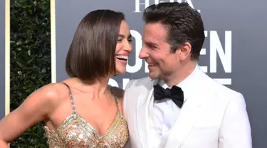 Model Rusia, Irina Shayk dan aktor Bradley Cooper tertawa saat tiba menghadiri Golden Globe Awards ke-76 di Beverly Hills, California (6/1). Irina dan Bradley mengubar kemesraan saat berjalan di karpet merah.  (AFP Photo/Valerie Macon)