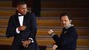 Striker PSG, Kylian Mbappe berjoget bersama DJ Prancis, Martin Solveig Mbappe setelah menerima penghargaan Trophee Kopa pada seremoni Ballon d'Or 2018 di Grand Palais, Senin (3/12). (FRANCK FIFE/AFP)