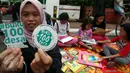 Seorang wanita memperlihatkan stiker saat kampanye "Budayakan Membaca dari Desa untuk Indonesia" saat berlangsungnya Hari Bebas Kendaraan Bermotor atau Car Free Day (CFD), Jakarta, Minggu (2/4). (Liputan6.com/Johan Tallo)