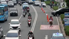 Pedagang kopi keliling melintas di Jalan Jenderal Sudirman, Jakarta, Kamis (9/7/2020). Badan Pusat Statistik (BPS), mencatat masyarakat berpendapatan rendah paling terdampak pandemi Covid-19, akibatnya, secara ekonomi kelompok tersebut paling tertekan. (Liputan6.com/Helmi Fithriansyah)