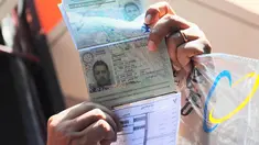 Petugas menunjukan paspor warga negara Iran saat rekonstruksi di Kantor Pos Pasar Baru, Jakarta, Selasa (1/7/14). (Liputan6.com/Faizal Fanani)