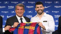Penyerang Sergio Aguero (kanan) berpose dengan presiden Joan Laporta selama presentasi resminya sebagai pemain baru Barcelona di stadion Camp Nou, Spanyol (31/65/2021).  Barcelona dan Sergio Aguero sama-sama sepakat untuk menyelipkan klausul pelepasan dalam kontraknya. (AFP Photo/Lluis Gene)